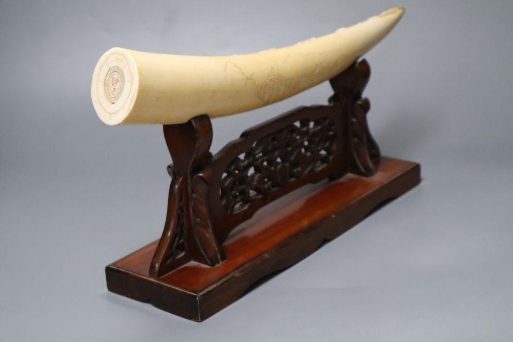 A Japanese ivory Seven immortals tusk carving, early 20th century, wood stand, signed, 44cm excl. stand